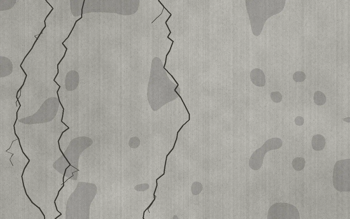 Close-up of a cracked concrete driveway with surface scaling from freeze-thaw and salt